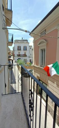 a balcony of a building with a flag on it at Romantico Rifugio in Guardiagrele