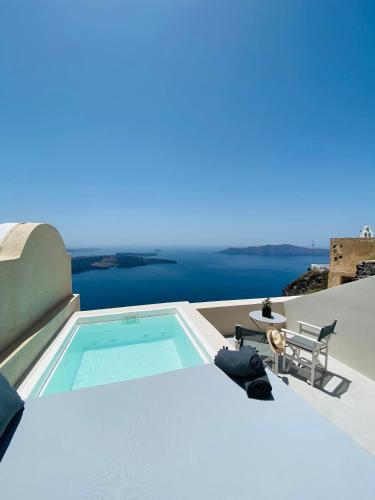 a swimming pool on the roof of a house at Ikia Kriton in Imerovigli