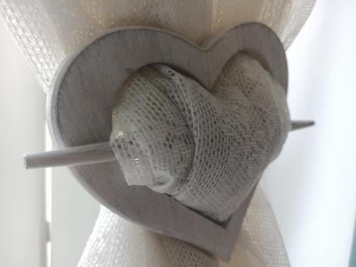 a heart made out of white lace on a window curtain at Romantico Rifugio in Guardiagrele