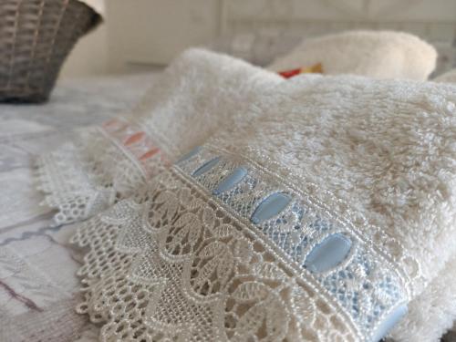 a white blanket sitting on top of a bed at Romantico Rifugio in Guardiagrele