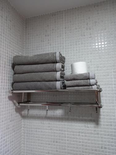 a stack of towels on a shelf in a bathroom at APARTAMENTO MOCHIMA in Cotillo