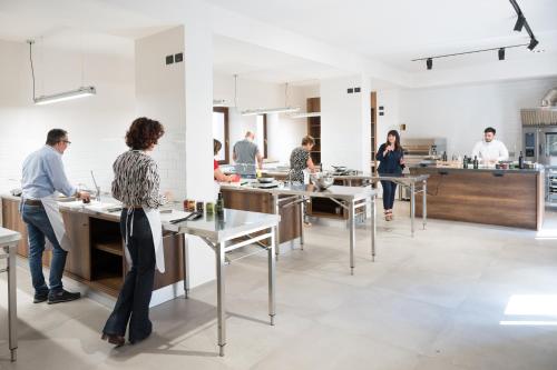 a group of people standing in a kitchen at Santoro Country House in Castiglione di Sicilia