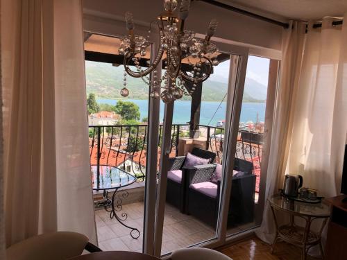 a living room with a chandelier and a balcony at Villa Stefanija in Ohrid