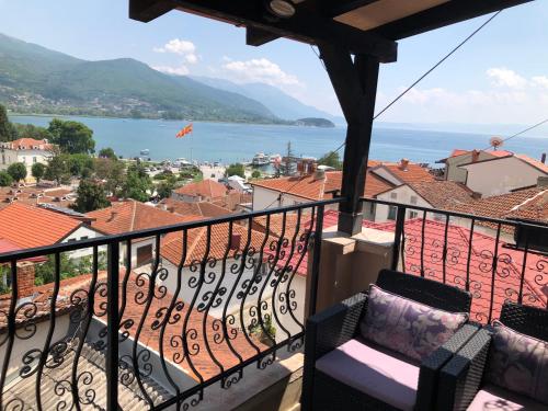 a balcony with a view of the water and buildings at Villa Stefanija in Ohrid