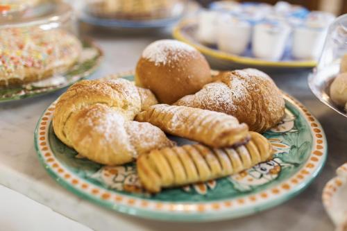 a plate of pastries and breads on a table at San Nicola in Agerola
