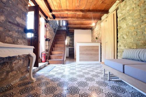 a living room with a couch and a staircase at Casa La Bohema in Afitos