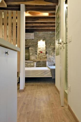 a bathroom with a tub in a room with a wall at Casa La Bohema in Afitos