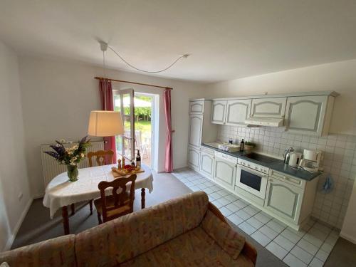 a living room with a couch and a table in a kitchen at NTAB10002-FeWo-Moeoevwarder-twee in Neue Tiefe Fehmarn