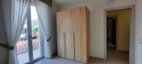 a large wooden cabinet in a room with a balcony at Vesuvius' Lovely Inn in Ercolano