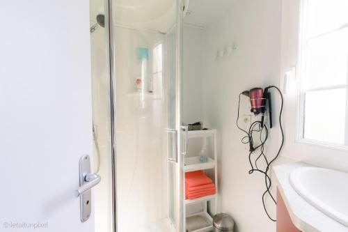 una doccia in un bagno con box doccia in vetro di LE COTTAGE DE LYXIE-Nature et sports a Talmont