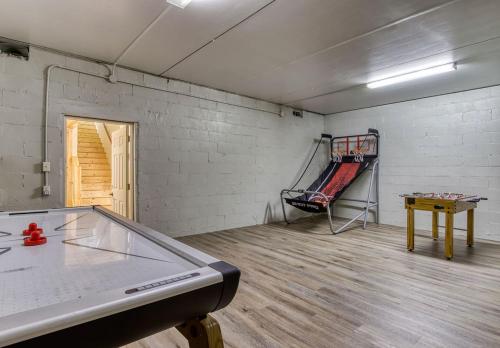 an empty room with a ping pong table and a ping pong table at Pigeon Forge Getaway, Hot Tub, Game Room, Wifi, 560 FREE tickets each paid day! in Pigeon Forge