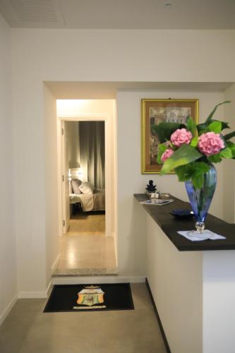 a room with a vase with flowers on a counter at B&B Costa degli Dei in Tropea