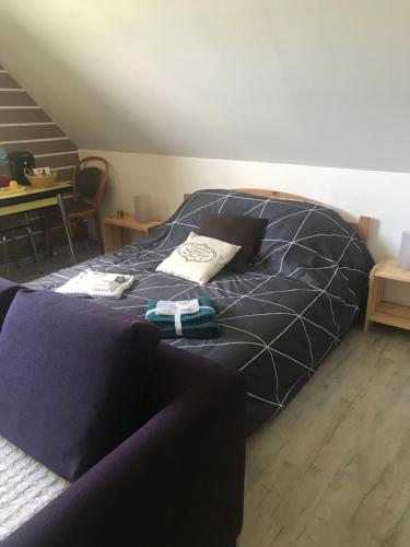 a large bed in a room with a table at La Marokanette in Saint-Maclou-de-Folleville