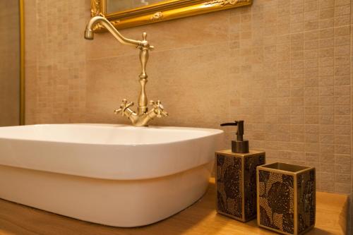 a bathroom with a white sink and a mirror at Luxury Villa Nature with heated private pool, sauna & fire pit, a short walk to the beach in Milna