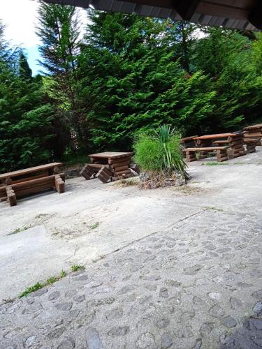 a group of picnic tables and benches in a park at Apartmani Dada Kanjon Grmuša in Bihać