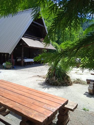 a wooden bench sitting in front of a building at Apartmani Dada Kanjon Grmuša in Bihać