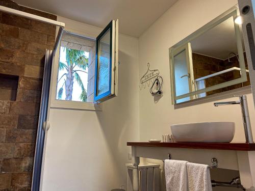 a bathroom with a sink and a mirror at PODERE CARAFA in Nardò