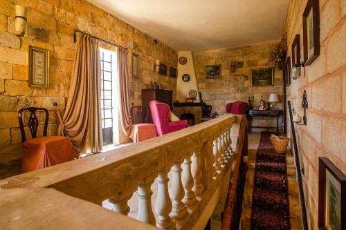 a staircase in a room with a stone wall at Ta' Bertu Host Family Bed & Breakfast in Ħal Far
