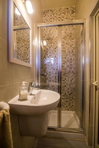 a bathroom with a sink and a shower at Ta' Bertu Host Family Bed & Breakfast in Ħal Far