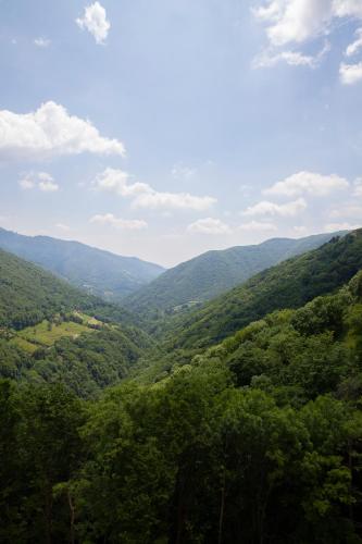 a view of a valley in the mountains at Osteria Manciana con Alloggio MONTE GENEROSO in Scudellate