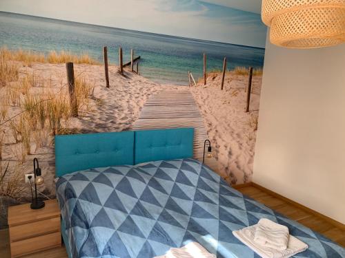 a bedroom with a bed and a wooden bridge to the beach at Nad morzem 62 in Władysławowo
