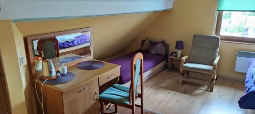 a bedroom with a bunk bed with a desk and a chair at Pokoje i kwatery w Augustowie in Augustów