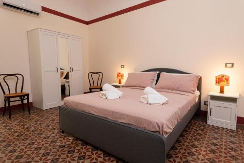 a bedroom with a bed with two pillows on it at La casetta di Maria alla Ciba in Termini Imerese