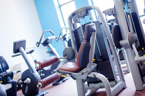a gym with cardio equipment in a room at Cedar Court Bradford Hotel in Bradford