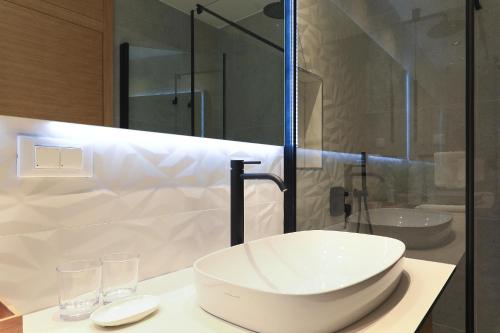 a bathroom with a large white sink on a counter at Luxury Aparthotel Zadar in Zadar