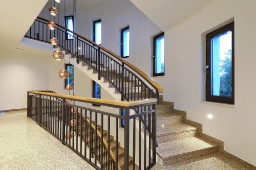 a spiral staircase in a home with windows at Luxury Aparthotel Zadar in Zadar
