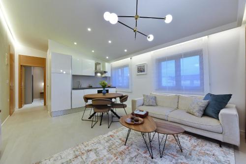 a living room with a couch and a table at Luxury Aparthotel Zadar in Zadar