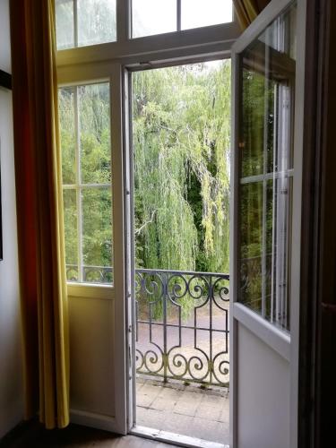 an open door to a balcony with a view at VILLA HENRI in Flavy-le-Martel