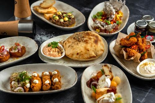 a bunch of plates of food on a table at Radisson Dubai Damac Hills in Dubai