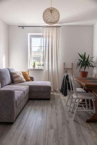 a living room with a couch and a table at W Sercu Mazur in Harsz