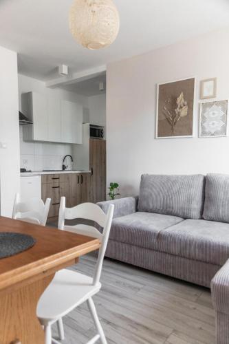 a living room with a couch and a table at W Sercu Mazur in Harsz