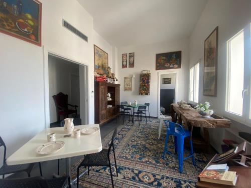 a living room with a table and chairs at BRIC à BRAC eclectic rooms in Uggiano la Chiesa
