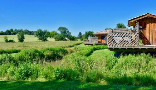 a house in the middle of a field at Chalets CASABELLA in Casteljaloux