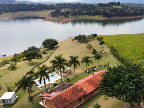 an aerial view of a resort next to a lake at Chalé Represa Recanto Varanda do Sol in Joanópolis