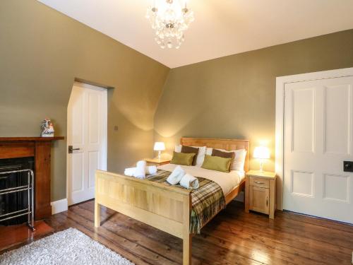 a bedroom with a bed and a chandelier at Bearnock Lodge in Inverness