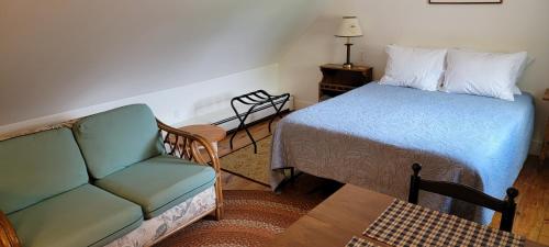 a living room with a bed and a couch at Hawks House Inn in Walpole
