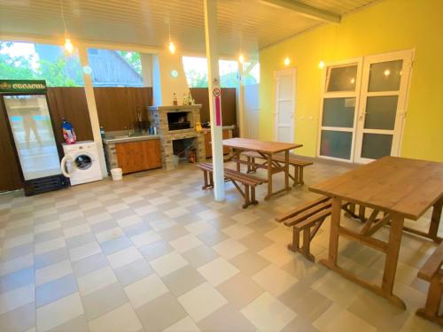 a living room with two tables and a kitchen at Solnechnaia Dacha in Zatoka