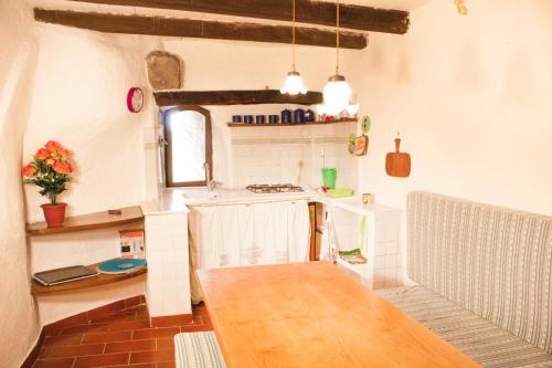 a kitchen with a stove and a counter top at Casa nella roccia in Bomarzo
