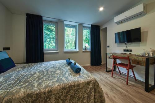 a bedroom with a bed with a teddy bear on it at "Parko vila" Anykščiai in Anykščiai