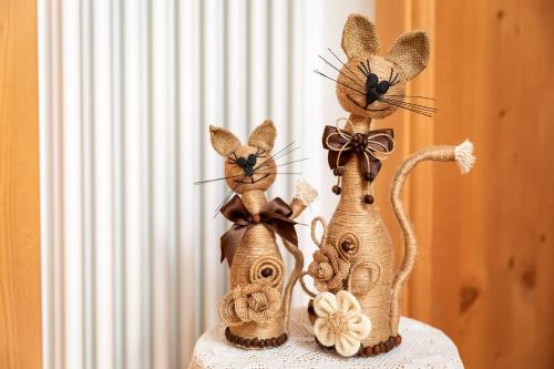 three wooden figurines of mice sitting on a table at Cèsa Raggio di Sole in Arabba