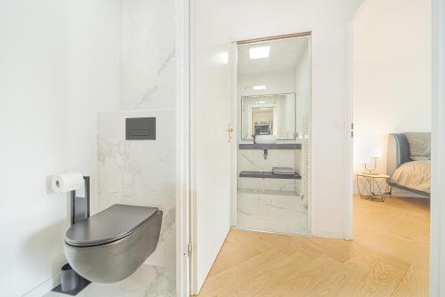 a bathroom with a toilet in a room at Disney and Paris * Netflix * Parking * 6 pers in Chessy