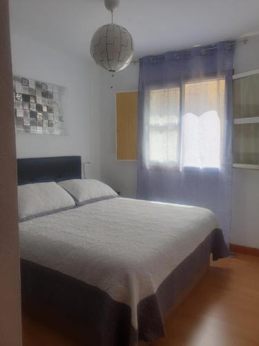 Schlafzimmer mit einem Bett und einem Fenster in der Unterkunft The family in Canfranc-Estación