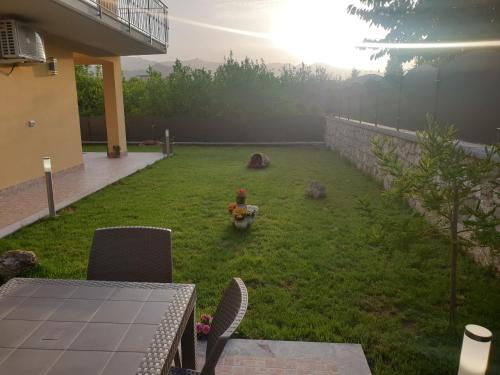 a yard with chairs and a stone wall at B&B Villa Chiara - Bed And Breakfast in Taormina