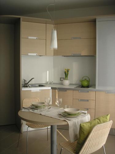 a kitchen with a table with plates and glasses on it at Residence Regina dei Prati in Mason Vicentino