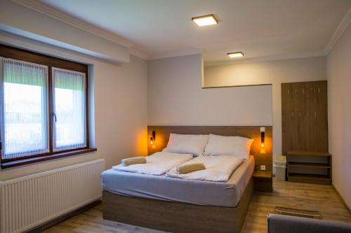 a bedroom with a large bed in a room at Kukorica Csárda Apartman in Balatonújlak
