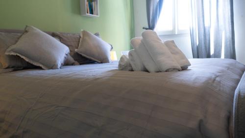 a bed with towels on top of it with a window at CASA ARISTON in Sassari